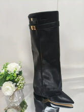 Black pointed-toe leather boot with gold buckles, structured fit, modern streetwear style