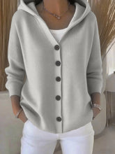 Light gray knit button-up hoodie cardigan with relaxed fit and long sleeves, paired with white pants