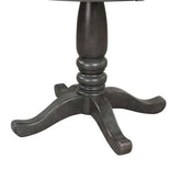 Close-up of a dark wood pedestal table base with curved legs, classic design