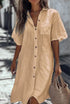 Woman wearing a loose fit beige linen button-down shirt dress with short sleeves