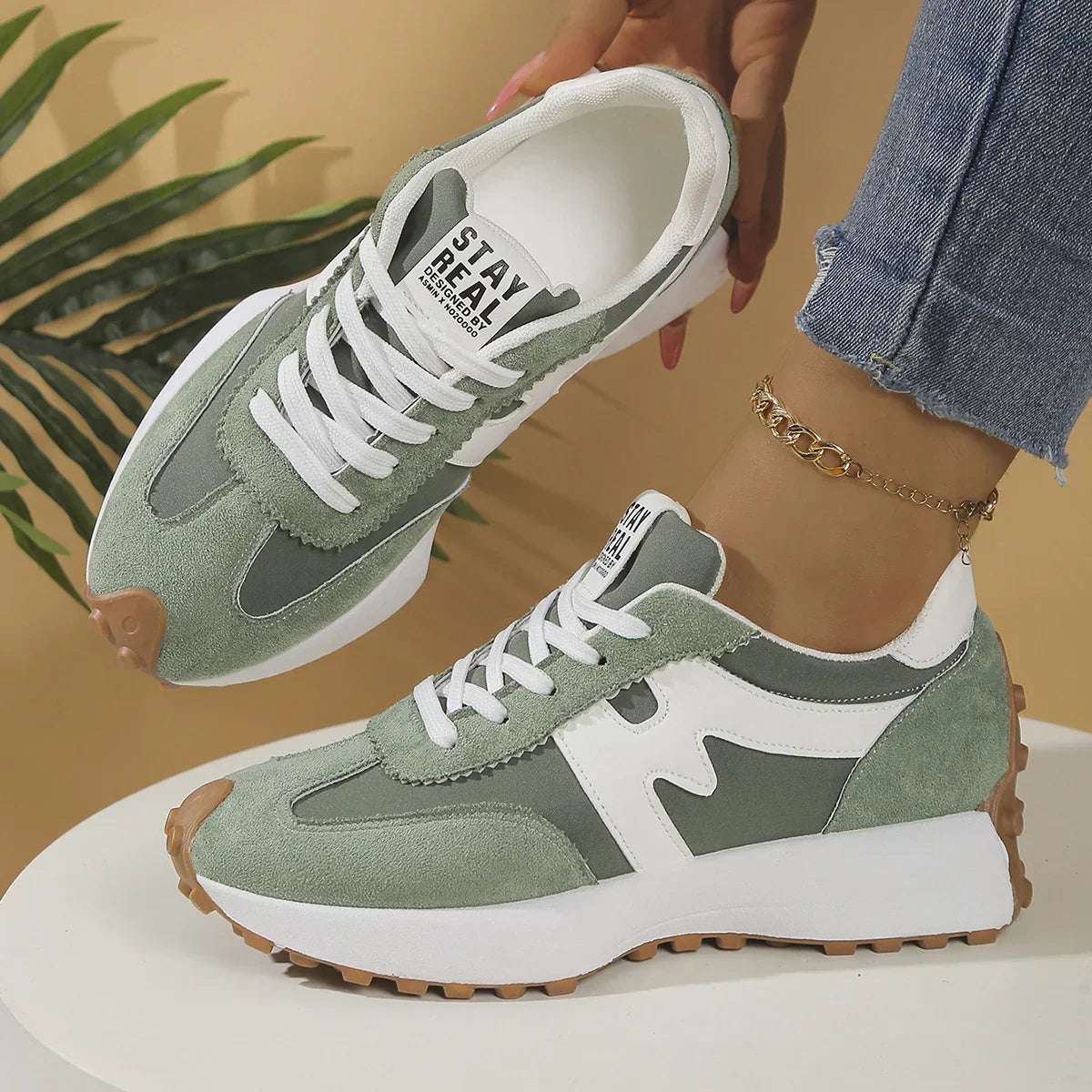 Sage green and white suede sneakers with chunky sole, lace-up design, casual fit