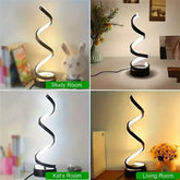 Modern spiral LED table lamp with black finish, soft white light, stylish home decor accent.