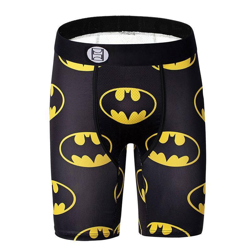 Men's black compression shorts with yellow superhero logo pattern, athletic fit, stretchy fabric