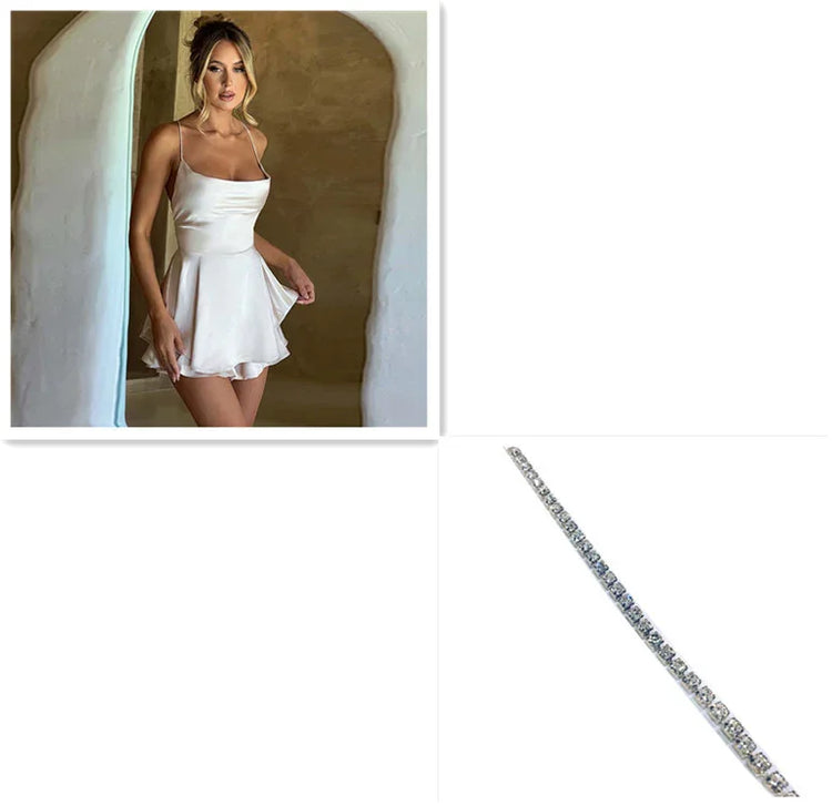 Woman in white satin mini dress with spaghetti straps and flared skirt, minimalist background