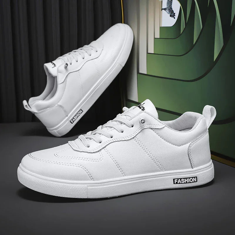 White low-top sneakers with lace-up closure, minimalist design, and synthetic leather material