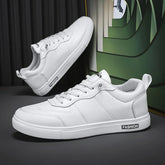 White low-top sneakers with lace-up closure, minimalist design, and synthetic leather material