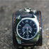 Black wide leather cuff watch with silver case, skull motif dial, rugged streetwear accessory