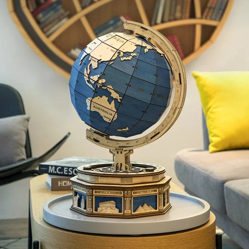 Wooden blue and beige globe model with detailed base on a modern coffee table