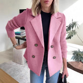 Woman wearing a pink double-breasted blazer with ribbed knit sleeves, relaxed fit, casual style