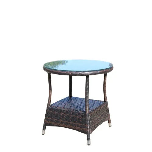 Round glass top outdoor side table with brown rattan frame and lower storage shelf