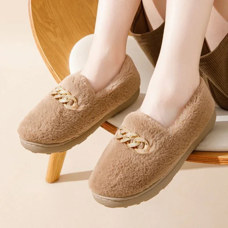 Beige faux fur slip-on slippers with gold chain detail, round toe, cozy fit.