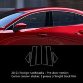 Red five-door hatchback car with glossy black window pillar trim stickers, exterior view