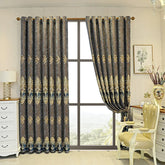 Luxury jacquard curtains with gold and blue damask pattern, fitted in an elegant living room.