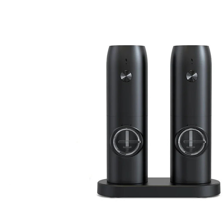 Pair of sleek black automatic salt and pepper grinders with adjustable settings on charging base