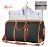 Black and brown leather travel duffel bag with garment holder and matching pouch, modern streetwear style.