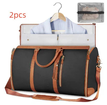 Black and brown leather travel duffel bag with garment holder and matching pouch, modern streetwear style.
