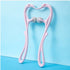 Pink plastic handheld massage roller with double textured wheels on a blue background