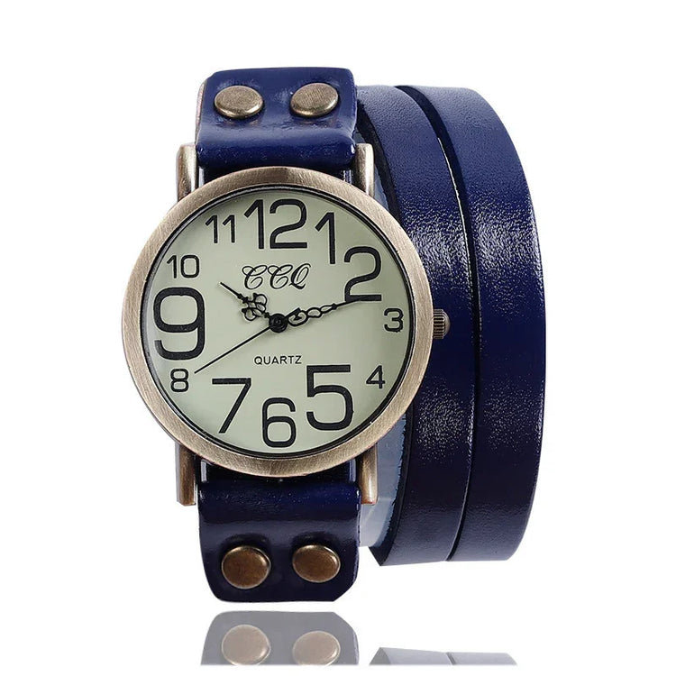 Vintage-style quartz watch with large numbers and wide blue leather wrap strap.