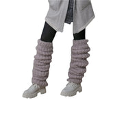 Chunky knit grey leg warmers over black leggings with white chunky boots, cozy streetwear style