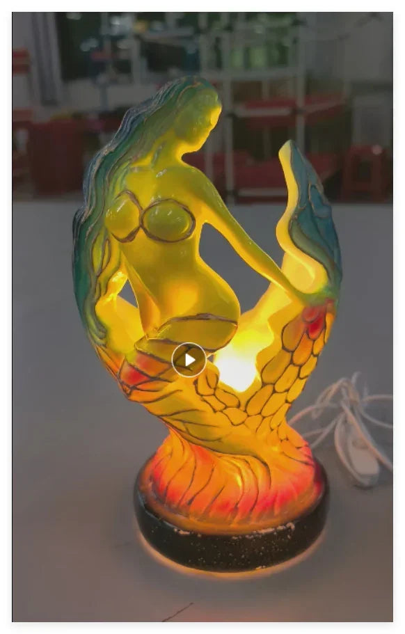 Colorful resin mermaid table lamp with glowing yellow and orange finish, decorative lighting