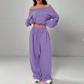 Woman wearing loose fit lavender off-shoulder sweatshirt and wide leg jogger pants set