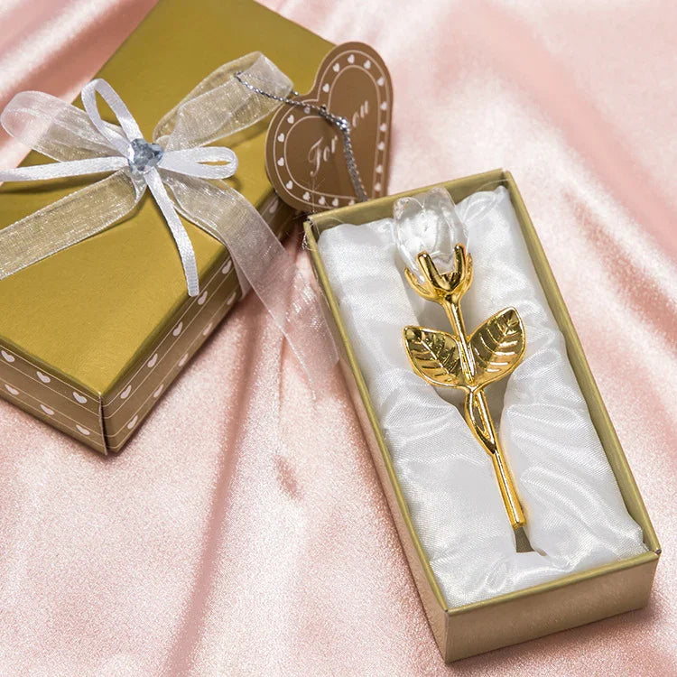 Gold-plated rose ornament in gift box on pink satin fabric