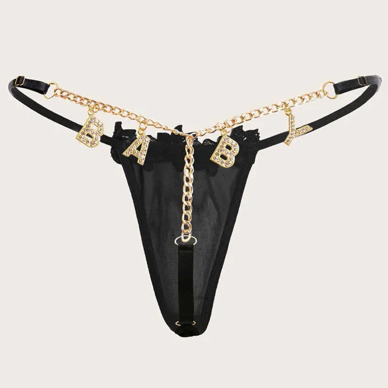 Black sheer thong with gold chain detail and rhinestone BABY lettering, adjustable straps