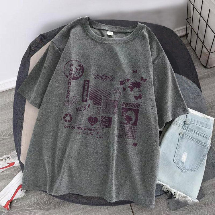 Oversized grey graphic t-shirt with abstract purple prints, paired with light denim shorts