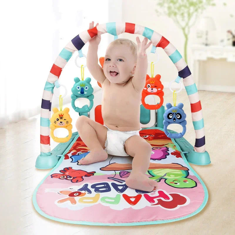 Baby in white diaper on colorful play mat with hanging animal toys, bright indoor setting