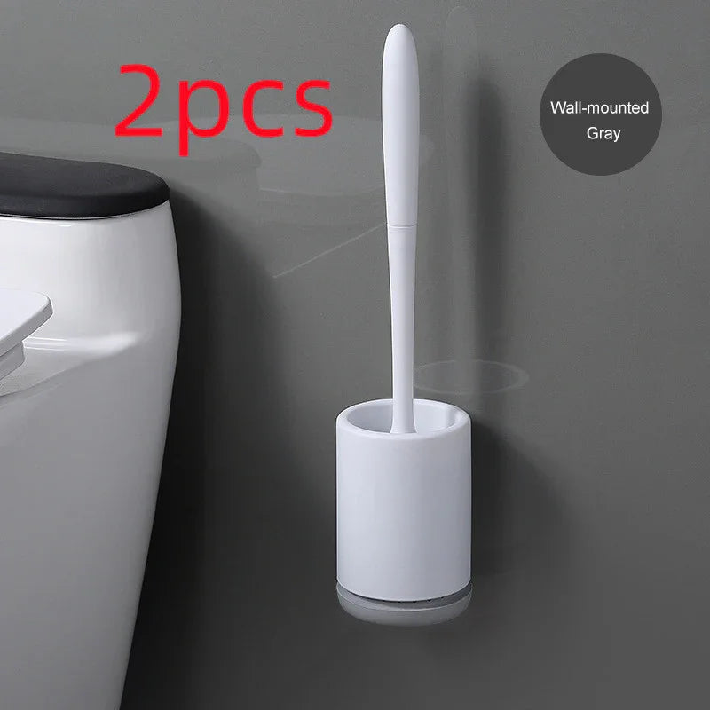 Minimalist gray wall-mounted toilet brush with white plastic holder next to a toilet