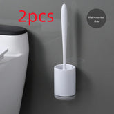 Minimalist gray wall-mounted toilet brush with white plastic holder next to a toilet