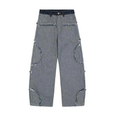 Wide leg grey denim jeans with exposed raw seams, frayed detailing, loose fit streetwear style