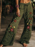 Olive green wide-leg linen pants with red floral embroidery and relaxed fit