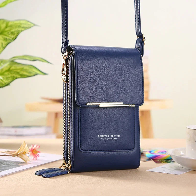 Navy blue faux leather crossbody bag with gold zippers and structured slim design