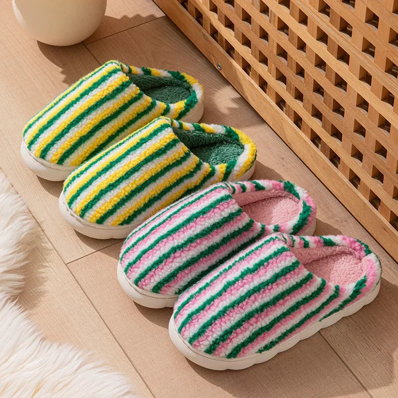 Fuzzy striped slippers in yellow, green, pink and white with cozy, plush material and closed-toe design