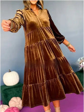 Woman wearing a loose fit brown velvet tiered midi dress with long sleeves