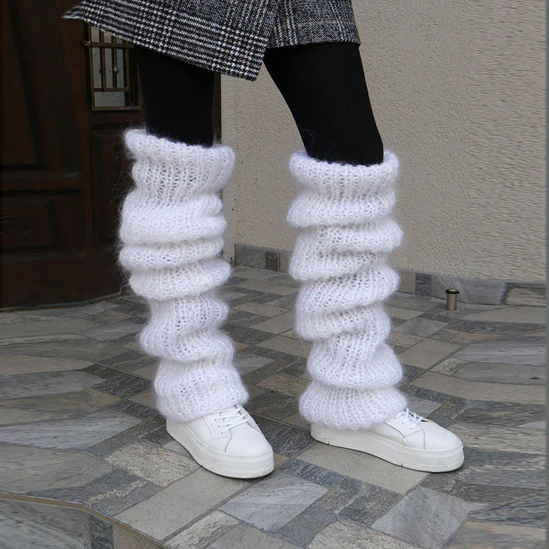 Chunky white knit leg warmers, textured wool, loose fit, styled with white sneakers and black tights