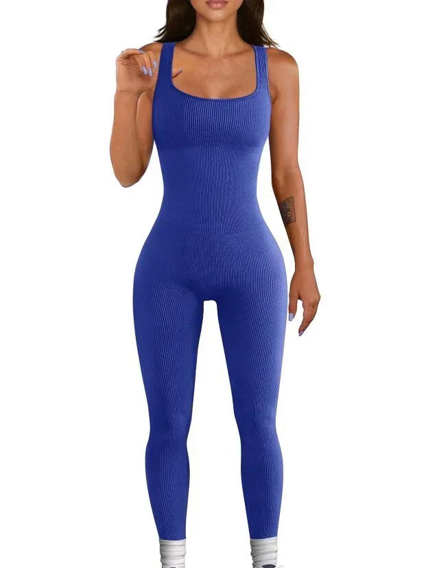 Woman wearing a fitted blue ribbed sleeveless jumpsuit with square neckline.