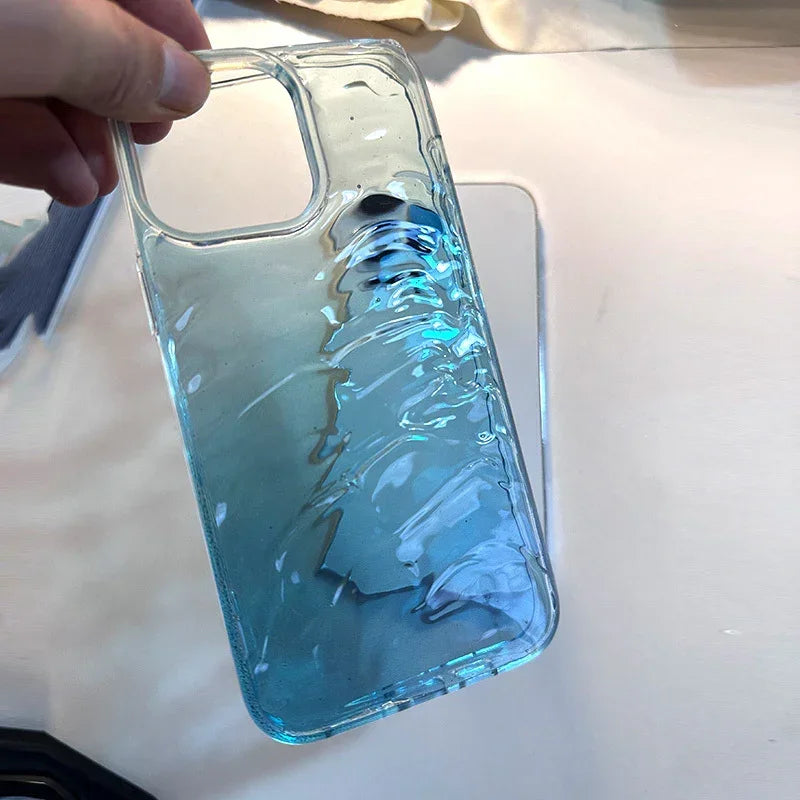 Clear blue gradient phone case with glossy, textured wave design, held in hand