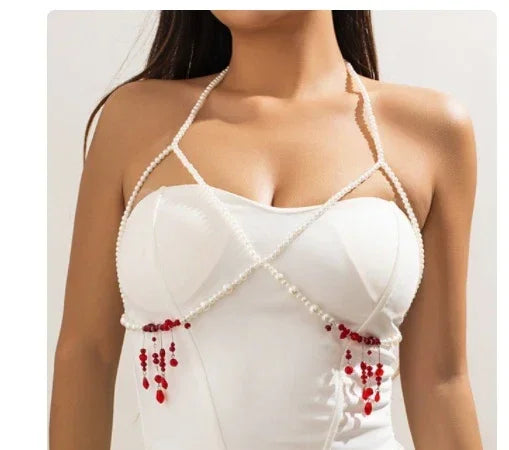White fitted halter top with pearl straps and red beaded accents, modern streetwear style