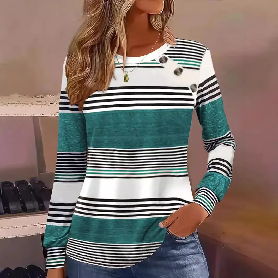 Woman wearing a teal, white, and black striped long sleeve top with button accents and relaxed fit.