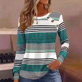 Woman wearing a teal, white, and black striped long sleeve top with button accents and relaxed fit.