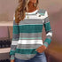 Woman wearing a teal, white, and black striped long sleeve top with button accents and relaxed fit.