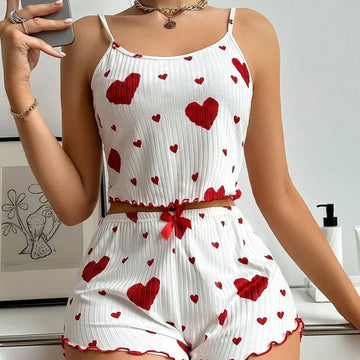 White ribbed camisole and shorts pajama set with red heart print, slim fit, ruffle trim.
