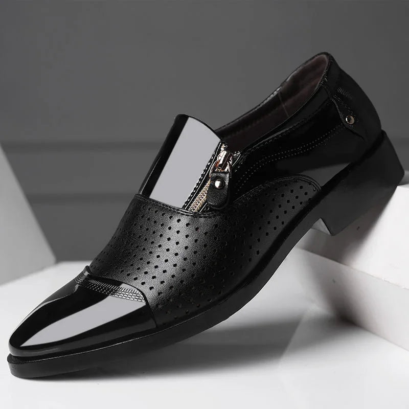Black glossy formal shoe with perforated leather, side zipper, and sleek pointed toe.