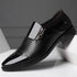 Black glossy formal shoe with perforated leather, side zipper, and sleek pointed toe.