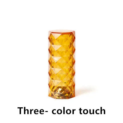 Amber-colored textured cylindrical tumbler glass with geometric diamond pattern