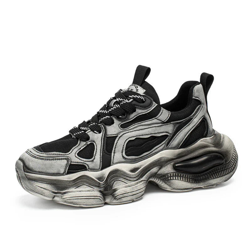 Chunky black and silver streetwear sneaker with mesh panels and thick sculpted sole