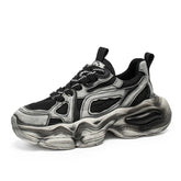 Chunky black and silver streetwear sneaker with mesh panels and thick sculpted sole