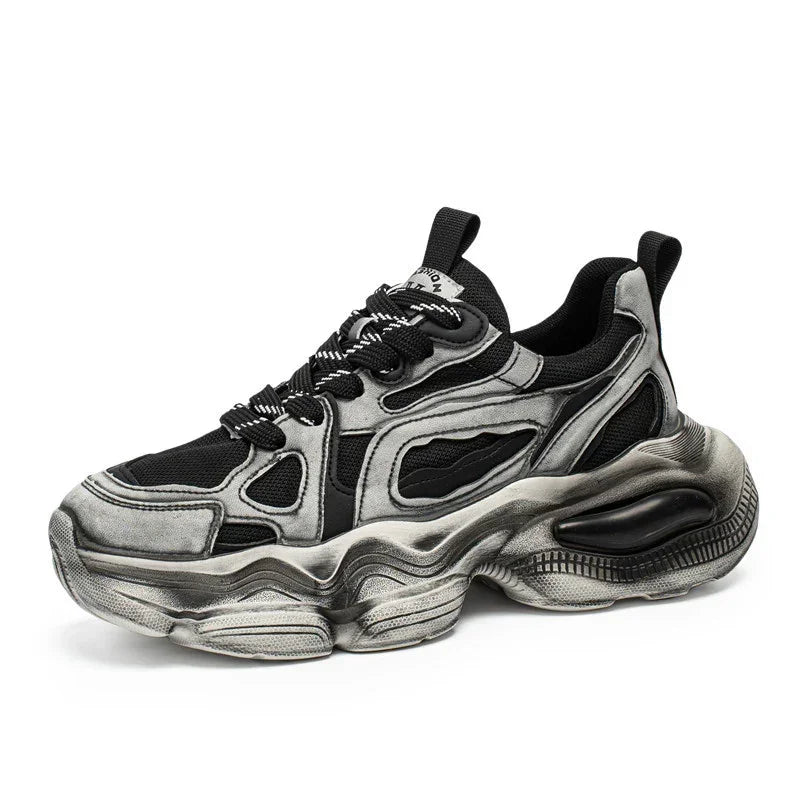 Chunky black and silver streetwear sneaker with mesh panels and thick sculpted sole